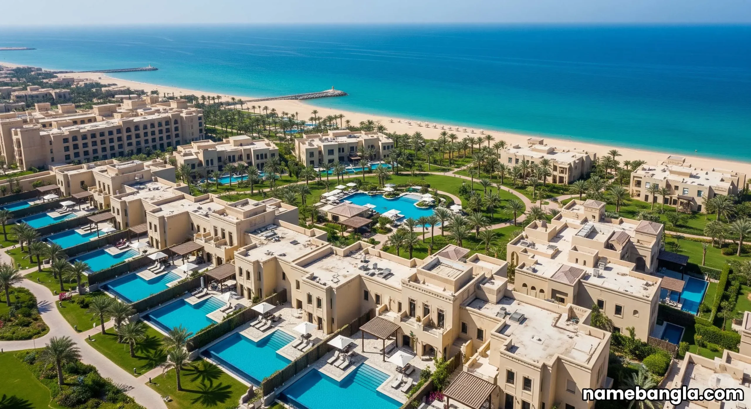 Aerial view of a sprawling luxury resort in Jeddah with multiple private pool villas by the sea, attracting high-value travelers.
