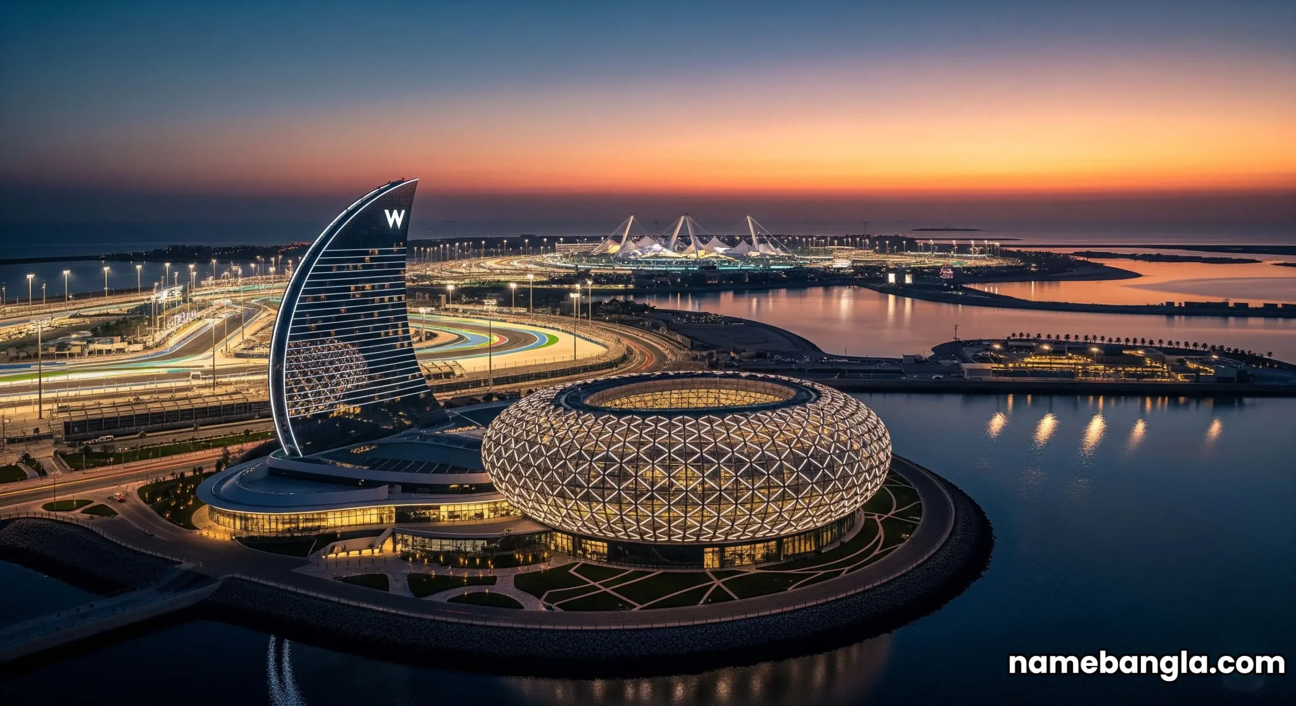 Aerial view of Yas Island, Abu Dhabi at twilight, highlighting the illuminated W Hotel and Yas Marina Circuit.