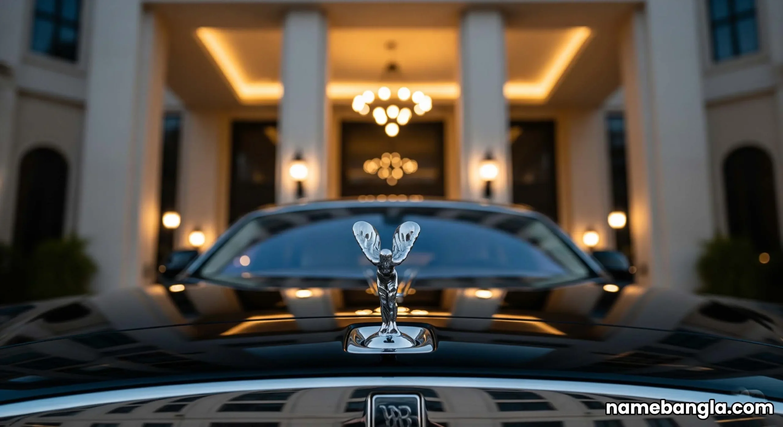 The grand entrance of the Waldorf Astoria Ras Al Khaimah hotel, with a luxury Rolls-Royce parked at the front, showcasing opulence.