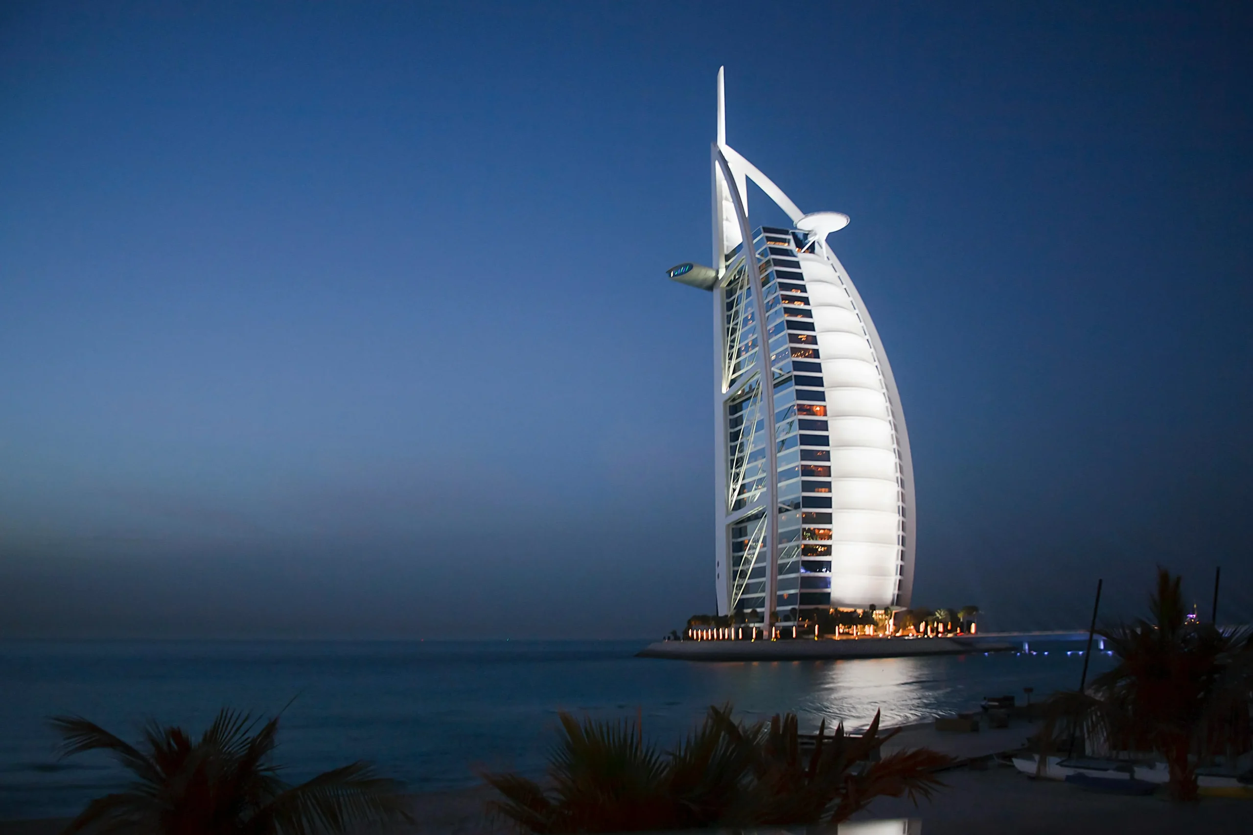 The iconic Burj Al Arab hotel in Dubai at dusk.