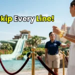 A high-net-worth individual bypassing the crowds using an exclusive Aquaventure Fast-Track VIP wristband at Atlantis Dubai.